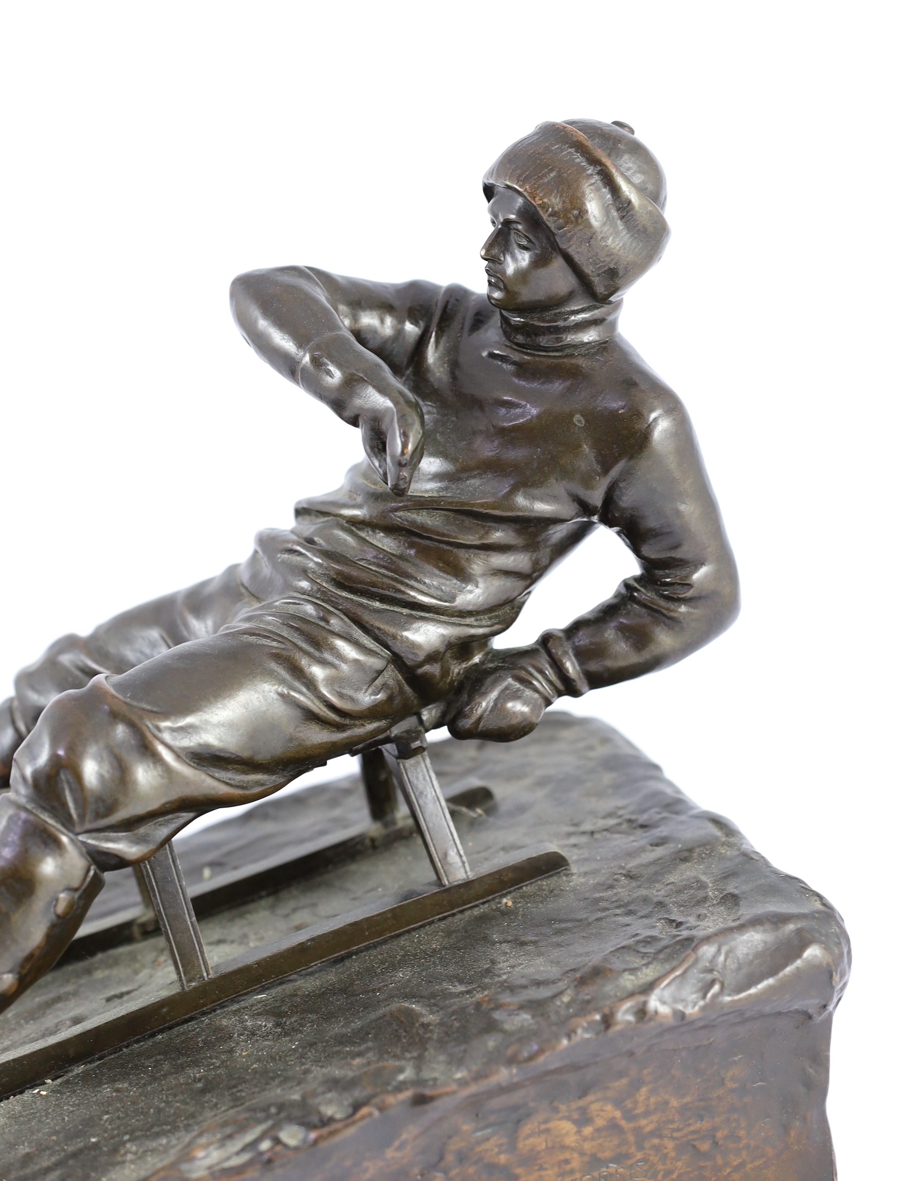 A late 19th / early 20th century German bronze model of a tobogganist, 30cm high 32cm long